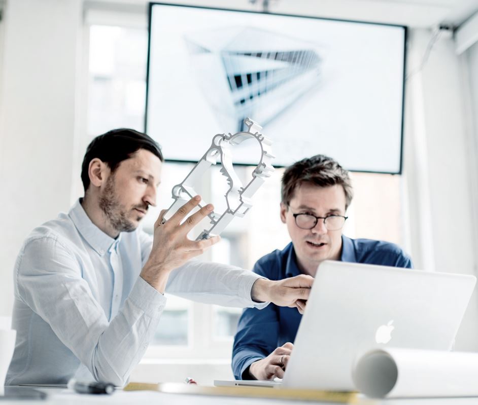 a person showing a person something on the computer